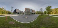 a 360 - view image of an office building in the middle of a park on a sunny day