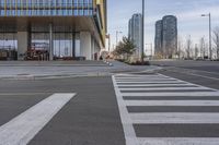 the building has a big number of windows in it that makes a nice contrast to the crosswalk