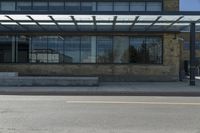 an empty building on a city street corner with yellow line and parking meter outside of the entrance