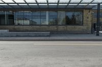 an empty building on a city street corner with yellow line and parking meter outside of the entrance