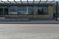 an empty building on a city street corner with yellow line and parking meter outside of the entrance