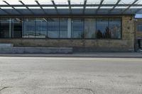 an empty building on a city street corner with yellow line and parking meter outside of the entrance