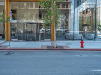 an empty street with buildings and parked cars on the sidewalks and green lanes on the sidewalk