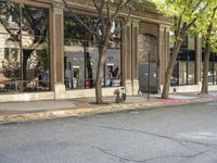 a store that is in a big city street with no cars on it, next to a fire hydrant