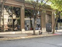 a store that is in a big city street with no cars on it, next to a fire hydrant