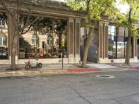 a store that is in a big city street with no cars on it, next to a fire hydrant