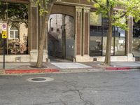 a store that is in a big city street with no cars on it, next to a fire hydrant