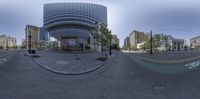 an upside down panorama of people walking in a city street with buildings and trees behind them