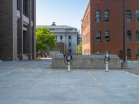 a street with a building near the building in the middle and on the left of which is a parking lot, as shown in this photo