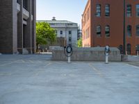 a street with a building near the building in the middle and on the left of which is a parking lot, as shown in this photo