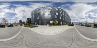 a fisheye lens view of an office complex and cars parked on a street below