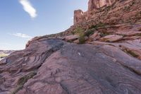 a trail is winding down a mountain, which is surrounded by rock formations and large boulders