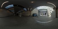 a fisheye lens panoramic view of an old airport building with glass ceiling