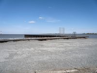 an old boat dock that is being partially destroyed by the water and surrounded by concrete