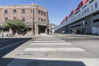 an old brick building with a car parked on the street in front of it is a commercial area next to the large warehouse