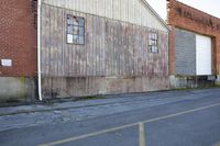 an old brick building is painted with red and yellow stripes and the brick in the background reads a ghost