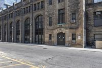 a very old building next to a parking lot with no cars or people in the street