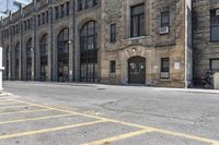 a very old building next to a parking lot with no cars or people in the street