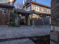 the entrance of an old chinese building and stone stairs that lead up to it's doorway