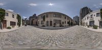 a 360 - lensed view of an old city street with cobblestone streets