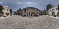 a 360 - lensed view of an old city street with cobblestone streets