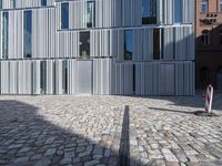 a brick street that has some cars in it and a building made out of aluminum foil