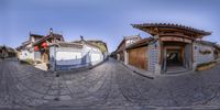 an image of an oriental setting with old houses and buildings in china, seen from inside the fish eye lens