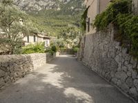 an alley in the old town of menton, france with a paved road running between two houses