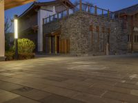 a building sits in the middle of an empty courtyard at night with lights lit up