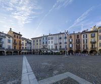 the old town square in a sunny day with an open cobblestone surface and lots of windows