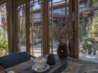 an open patio with an oriental tea cup and teapots and a table set outside