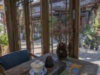 an open patio with an oriental tea cup and teapots and a table set outside