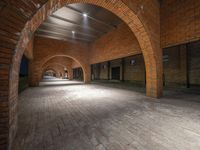 an archway leads to two rooms and an entranceway inside an old warehouse building with brick walls