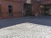 an older bricked walkway leads to a book store on the other side of the road