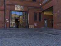 an older bricked walkway leads to a book store on the other side of the road