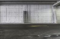 a broken toilet in the middle of an empty parking garage with concrete walls and cement floor