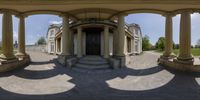 a panoramic view of an entrance with columns and arches on a sunny day