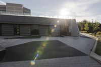 a view of an outside area of an office building with large windows and a circular driveway