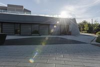 a view of an outside area of an office building with large windows and a circular driveway