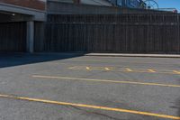 a empty parking lot with a yellow stop sign in front of a building and some other buildings