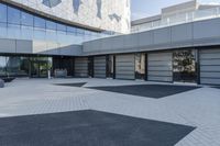 a view of an outside area of an office building with large windows and a circular driveway