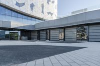 a view of an outside area of an office building with large windows and a circular driveway