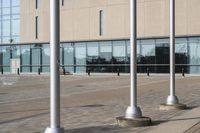 a parking meter is in front of a building with glass walls and columns on the side