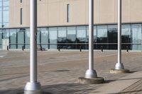 a parking meter is in front of a building with glass walls and columns on the side