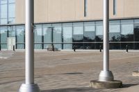 a parking meter is in front of a building with glass walls and columns on the side