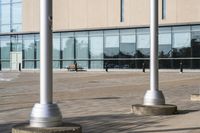 a parking meter is in front of a building with glass walls and columns on the side