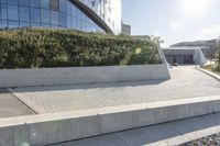 a view of an outside area of an office building with large windows and a circular driveway