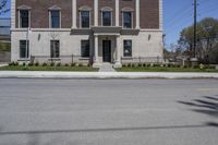 a building with the door open and on the sidewalk behind it is an empty street