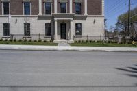 a building with the door open and on the sidewalk behind it is an empty street