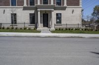 a building with the door open and on the sidewalk behind it is an empty street